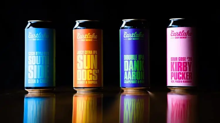4 cans of Eastlake Craft Brewery beer with their new branding.